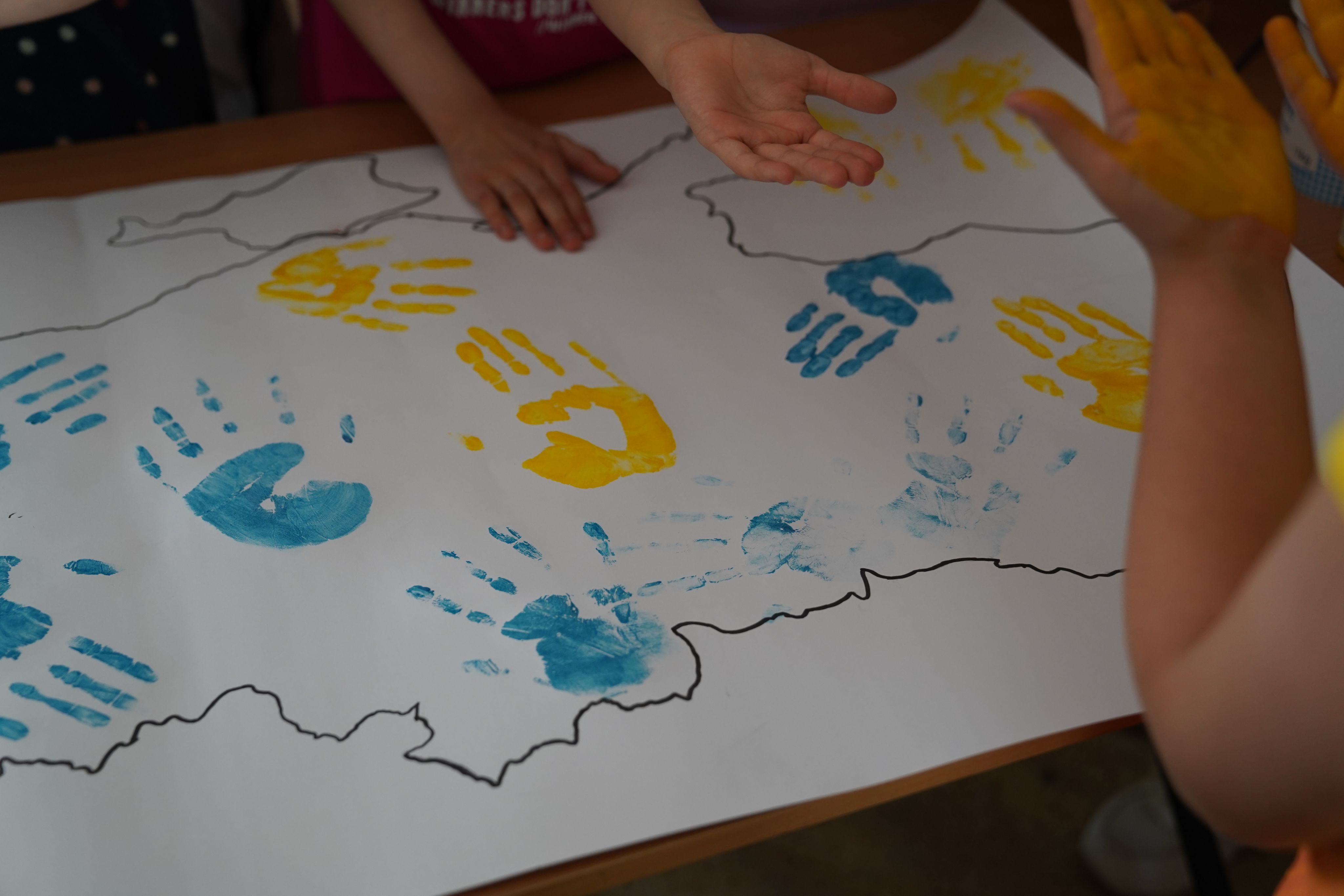 Children leave handprints on Ukraine's map during psychosocial activities in a collective centre for displaced families in Kharkiv, Ukraine