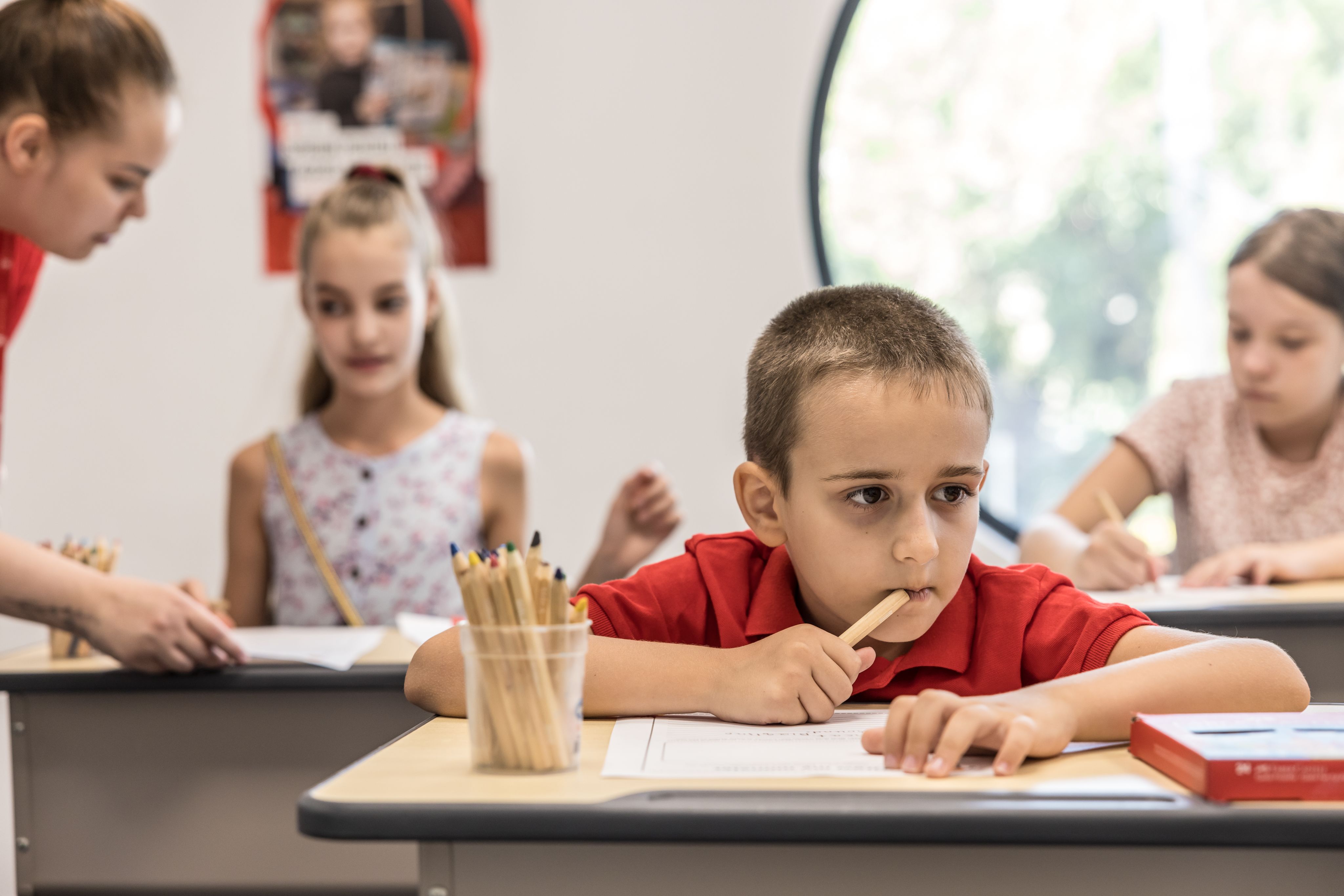 Marko*, eight, taking part in an English lesson, at Save the Children's hub, Bucharest, Romania