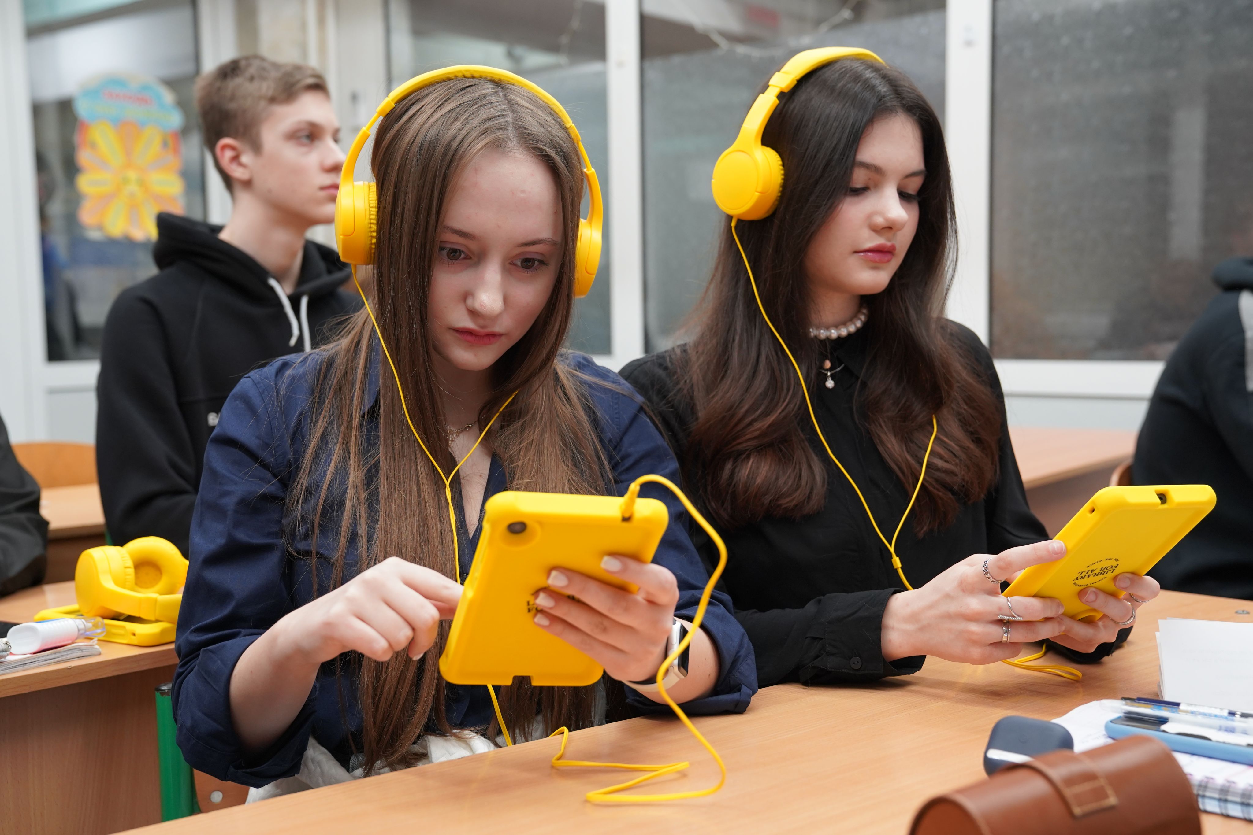  Olena*, 16, and Maryna*, 17, use tablets during classes at a subway school in Kharkiv, Ukraine.