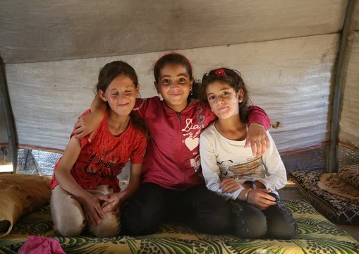 CH1732023-Hanin-11-Lujain-11-and-Lujains-nine-year-old-sister-Lina-inside-of-a-tent-in-the-displacement-camp-where-they-live-with-their-families-in-Syria