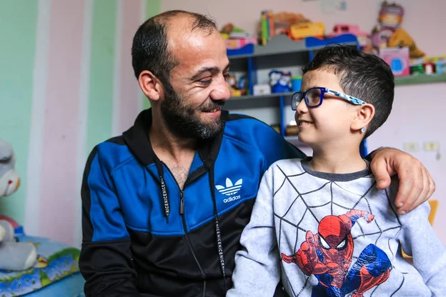 CH1685083-Bassem-8-at-home-with-his-father-Youssef-in-Gaza-occupied-Palestinian-territory.aspx%3Fwidth%3D1200%26height%3D675%26ext%3D.jpg.webp