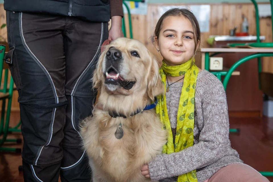 CH1759674-Viktoriya-9-poses-with-golden-retriever-Parker-a-two-year-old-therapy-dog-during-a-dog-therapy-session-at-a-school-outside-of-Kyiv-Ukraine.jpg%3Fext%3D.jpg.webp