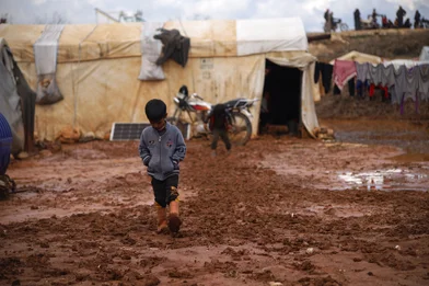 CH1793340-A-child-playing-and-walking-through-flood-water-and-mud-in-a-camp-for-internally-displaced-people-in-Idlib-Syria.JPG CH1793340-A-child-playing-and-walking-through-flood-water-and-mud-in-a-camp-for-internally-displaced-people-in-Idlib-Syria.JPG