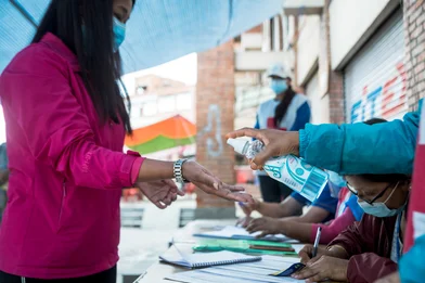 CH1553547-Woman-sanitises-hands-at-vaccination-centre-Nepal.jpg CH1553547-Woman-sanitises-hands-at-vaccination-centre-Nepal.jpg