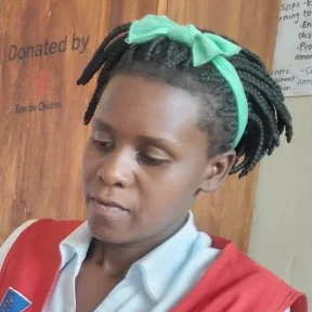 Evelyn-Katusabe-in-the-staffroom-preparing-books-for-marking