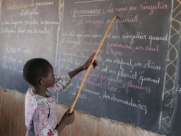 CH1545245-Souleymane-aged-14-points-to-words-on-a-blackboard-at-school-Yatenga-province-Burkina-Faso.aspx%3Fwidth%3D1200%26height%3D900%26ext%3D.jpg.webp